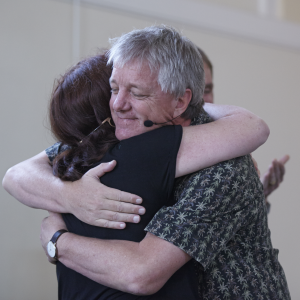 Stephen Gilligan and client hug
