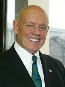 Headshot of Stephen Covey, smiling and wearing a suit and tie