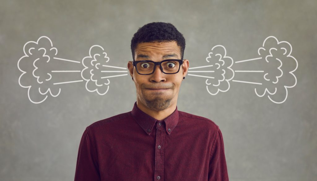 Man Grimacing with Steam Coming Our of His Ears